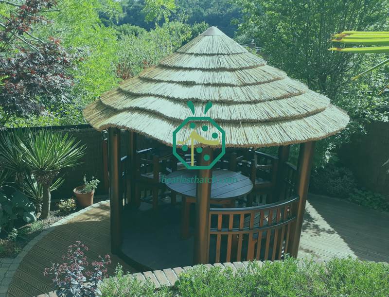 Synthetic gazebo reed thatching roof creates a versatile garden space